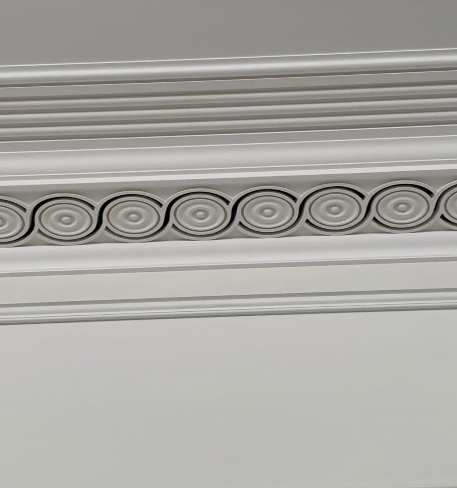 Decorative plaster cornice with integrated air ventilation holes, combining traditional moulding with modern functionality